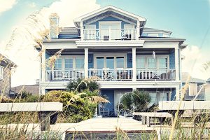 Ortley Beach real estate agent, Blue beach house with 3 porches with beach grass