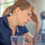 Woman pondering with head in hand if duct service in Freehold is right for her